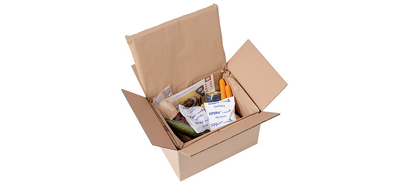 Image of an open shipping box containing food and ice packs.