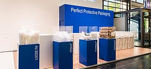 A Storopack trade fair stand with four blue display cases